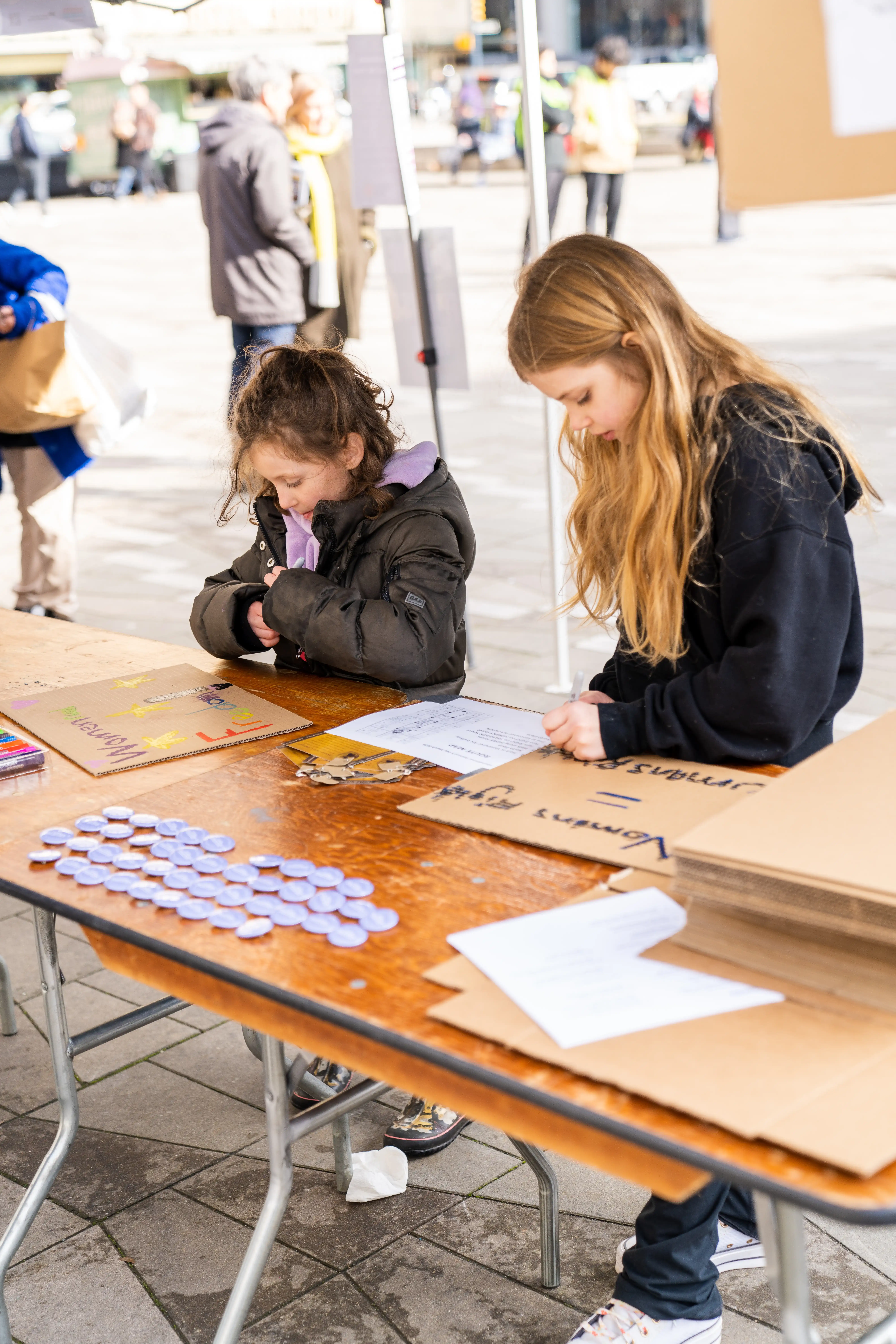 This is an image of two young children, making signs on cardboard at the 2023 event.