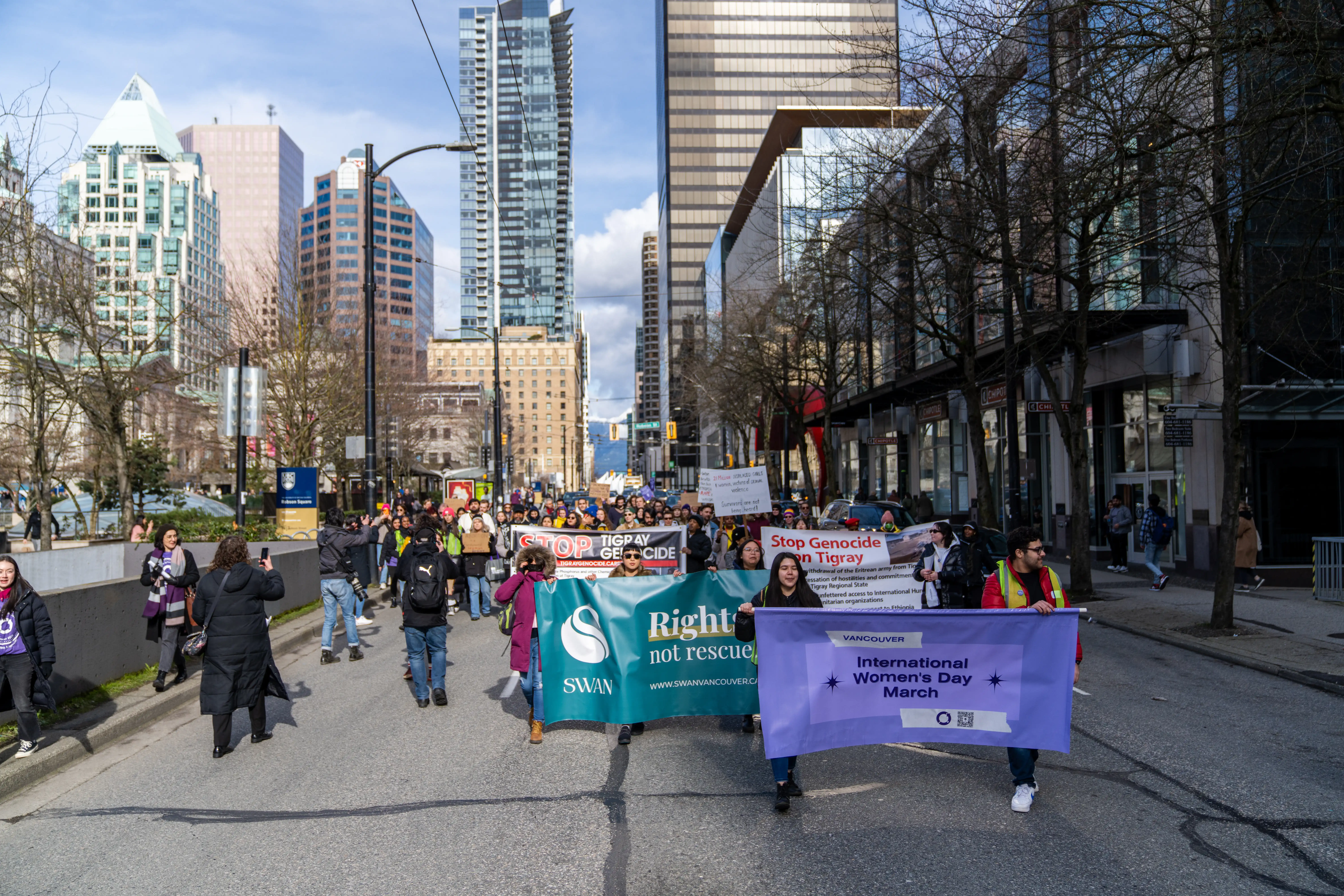 This is an image of the crowd at the 2023 march. There are multiple people standing outside of the Vancouver Art Gallery.