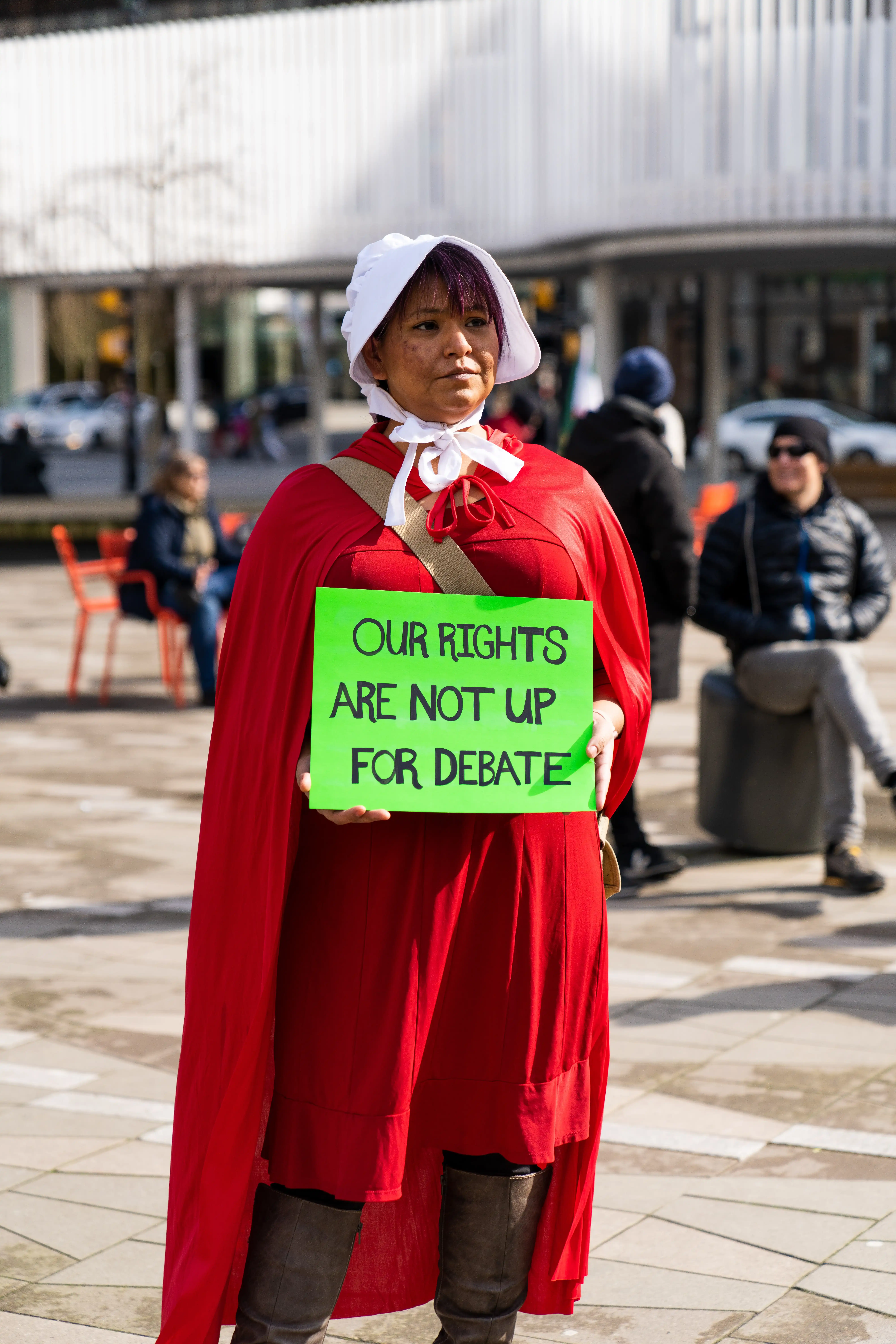 This is an image of an attendee from the 2023 march. They are holding a sign that reads Our Rights are not up for debate. 
